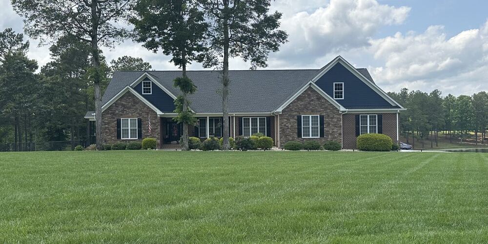 Completed brick ranch home with attached porch, built by J. Severt Contracting